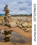 Inukshuls built by tourists at Baie Johan Beetz park, on the shore of St Lawrence river, in Cote Nord region of Quebec (Canada)