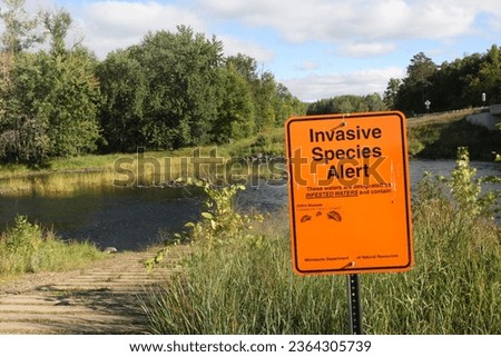 Invasive species zebra mussels warning sign at Pine River boat landing in north central Minnesota.