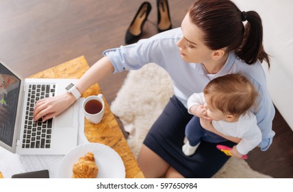 Inventive contemporary mom multitasking in the morning - Powered by Shutterstock