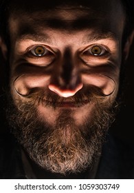 Inventor Hipster With Beard And Mustages In The Dark Room. Smiling Trickster.