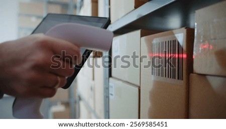 Inventory Manager Scans Code on Cardboard Box with Barcode Scanner, Checks Parcel Information. Tablet Computer Screen Shows Delivery Tracking System for Monitoring Package with Online Orders. Close Up