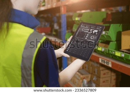 inventory manager worker using warehouse management system on tablet computer for tack checking products lots storage location