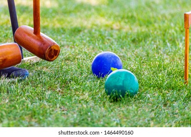 Inventory for playing croquet on a green lawn.