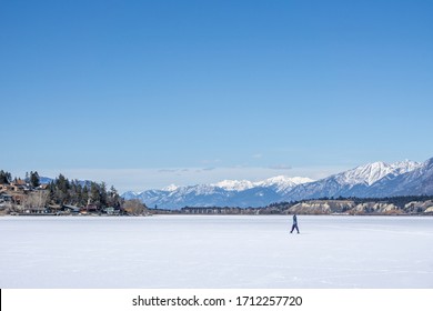 INVERMERE, CANADA - MARCH 17, 2020: frozen Windermere lake and rocky mountains in british columbia canada.