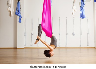 Inversion bow pose in aero anti gravity yoga. Aerial exercises