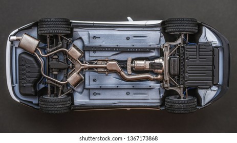 Inverted Car On A Black Background. Bottom View Of Car