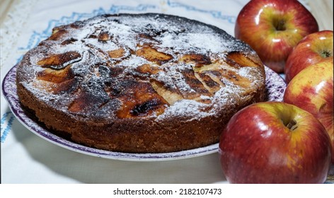 Inverted Caramel Apple Cake With Some Fruits Around It