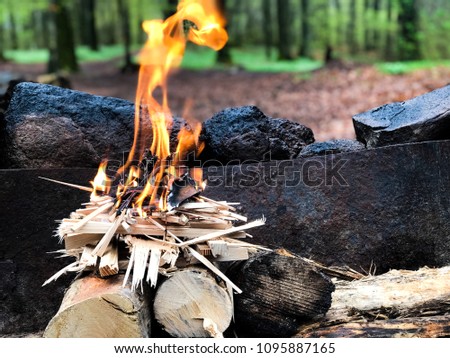 Inverted fire pit with logs on the bottom and tinder on top