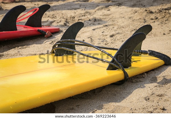 inverted surfboard on the\
sand