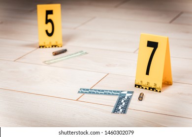 The Investigation Of The Crime Scene-collecting Bullet Shells On The Tiled Floor.