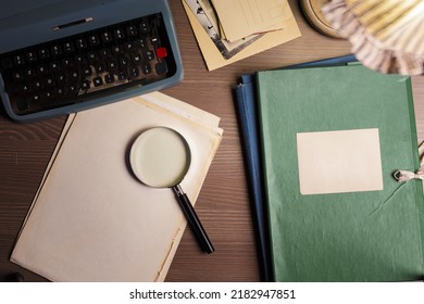 Investigator desk with secret documents, magnifying glass, vintage typewriter 