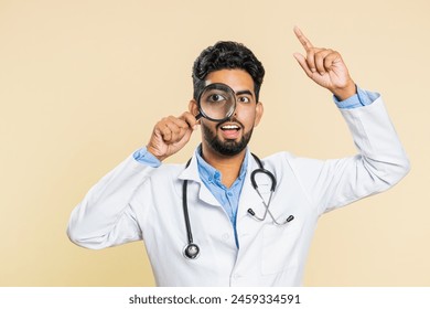 Investigator researcher scientist Indian young doctor cardiologist man holding magnifying glass near face looking , searching, analyzing. Arabian apothecary pharmacy guy isolated on beige background - Powered by Shutterstock