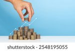 Invest,Investment,saving money and planning businesses. Man holds coin in his hand with coins stack and uparrow Indicating profit and growing business