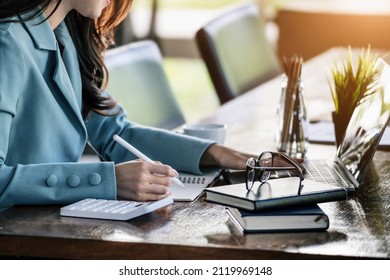 Investment concepts, businesswomen use document and computers to analyze stock markets, quantitative data collection, financial statement analysis, profitability through internet technology - Powered by Shutterstock