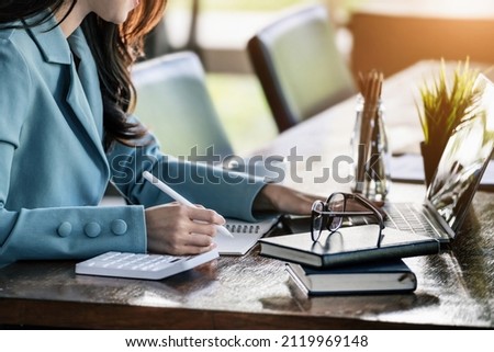 Investment concepts, businesswomen use document and computers to analyze stock markets, quantitative data collection, financial statement analysis, profitability through internet technology