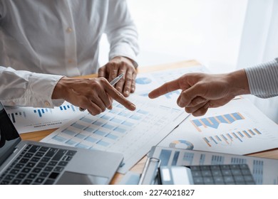 Investment finance concept, group of business people pointing to the graph Business Advisory Meetings and Strategic Brainstorming financial analysis investment and marketing new business project. - Powered by Shutterstock