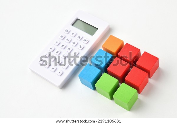Investment portfolio images, colorful wooden\
blocks and\
calculator