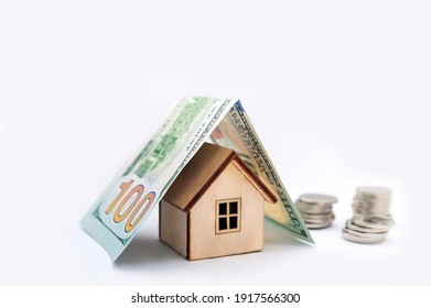 Investment real estate concept. Mortgage concept for money house made of coins. House Model Money White Background Savings Plans Housing Finance Banking. wooden house model on pile of Euro banknote