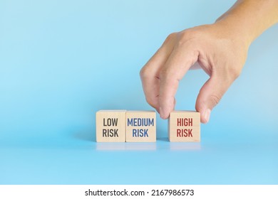 Investment Risk Management Tolerance And Planning And Asset Allocation And Diversification Concept. Wooden Blocks With Low, Medium And High Risk Word With Copy Space.
