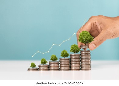 Investment and saving money concept. A man placing coins with growing tree  with white up arrow of financial developments and business growth - Powered by Shutterstock