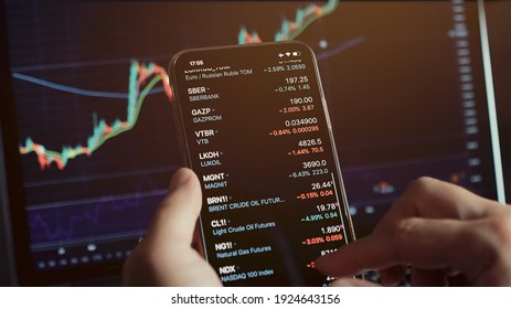 investment stockbroker stock market analysis data graph with price rates. Stock market trader analyzing bitcoin price trend. Investment broker trading bitcoin crypto currency using phone and laptop. 