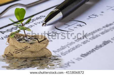Investment valuation concept.Double Exposure of sprout growing from coins in money bag and Pen on Discount cash flow model background.