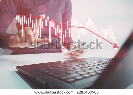 Investor analyze stock chart with laptop, businessman forecast and analysis graph in Bearish downtrend, economic slowdown, inflation crisis, loan interest rise, trade war finance, covid-19 impact.