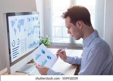 Investor analyzing financial reports and key performance indicators (KPI) of stock market on the computer screen with business intelligence (BI) analytics and graphs at the office