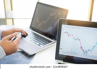 Investor Analyzing Financial Reports Of Stock Trading Market Graph Investment Charts On Computer Monitor Screen In The Office