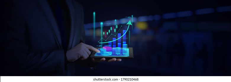 investor or business man and using tablet with graphic candle stick graph chart of stock market investment trading for Forex trading, internet, investment and global business concept.