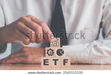 Investor holds the wooden cube with bitcoin icon standing with ETF text. Entering the digital money fund. ETF Exchange Traded Fund, business finance conceptual.