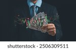 Investor or trader holding dollar bill show virtual stock hologram. concept of Financial business,Planing investment in trading the stock market, mutual fund, bond, digital asset.