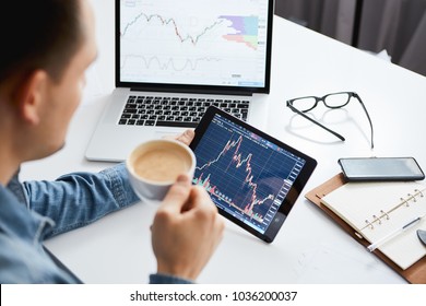 Investor watching the change of stock market on tablet. - Shutterstock ID 1036200037