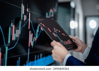 Investors analyze graph data stock market index via digital tablet screen to trade the stock chart for planning investments take profit, trade stock exchange market and cryptocurrency data, financial. - Powered by Shutterstock