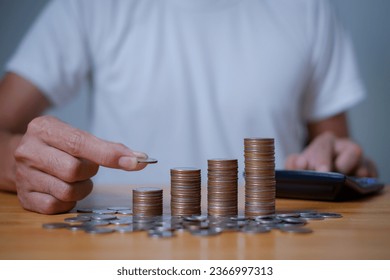  investors man are placing coins in a growing position with savings finance money concept,Save money for future and Retirement. - Shutterstock ID 2366997313