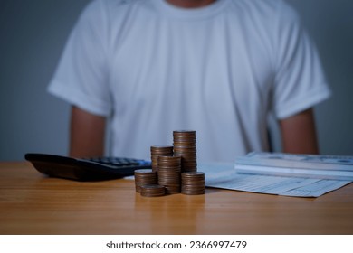  investors man are placing coins in a growing position with savings finance money concept,Save money for future and Retirement. - Shutterstock ID 2366997479