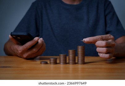  investors man are placing coins in a growing position with savings finance money concept,Save money for future and Retirement. - Shutterstock ID 2366997649