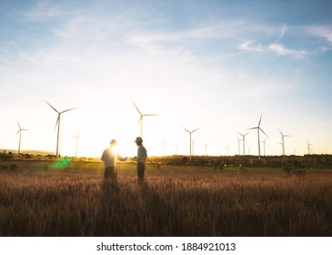Investors And Technician Who Are Out Of Focus In The Foreground Are Standing In Talks About Wind Turbine Power Generation, Wind Turbine Farm Is An Alternative Electricity Source For Business.