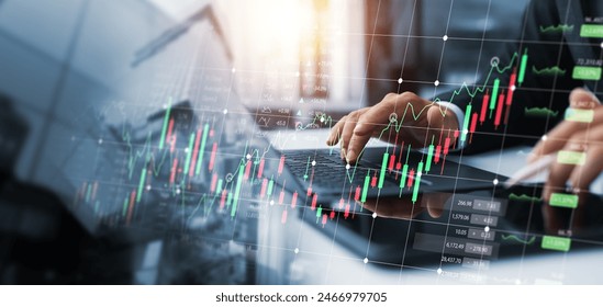 Investors use laptops to analyze stock market, investment strategies. and business growth analysis, investing in companies with long-term competitive advantages, against the backdrop of the city. - Powered by Shutterstock