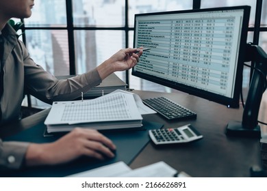 Investors working on desk office and use computer  to check data cost, balance, profit and  currency. Accounting and  Financial concept.