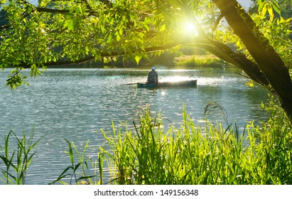 Inveterate Fisherman In A Boat On The Lake. Summer Fishing 