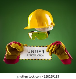 invisible builder in a yellow helmet with an information banner on a green background