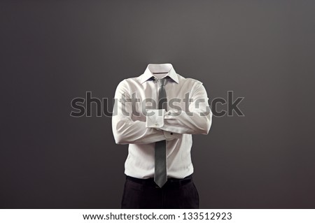 invisible man standing with folded arms over his chest against grey background