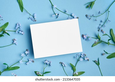 Invitation Or Blank Greeting Card Mockup With Forget-me-not Flowers On Blue