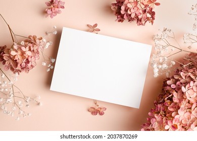 Invitation card mockup with hydrangea and gypsophila flowers decorations. Blank greeting card mockup.