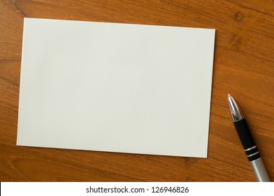 Invitation Card With Pen On Wood Table