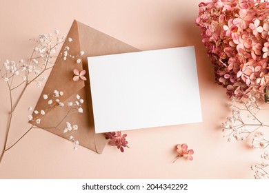 Invitation or greeting card mockup with envelope, hydrangea and gypsophila flowers. Blank card mockup on pink background. - Shutterstock ID 2044342292