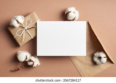 Invitation Or Greeting Card Mockup With Gift Box, Envelope And Natural Cotton Plant Flowers Decorations, Top View, Copy Space