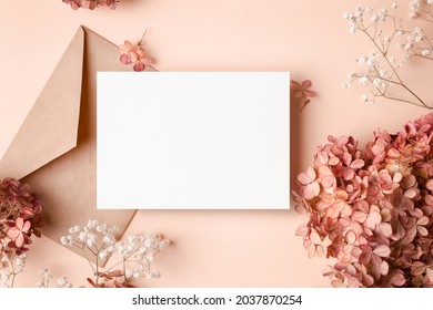 Invitation or greeting card mockup with hydrangea and gypsophila flowers decorations.