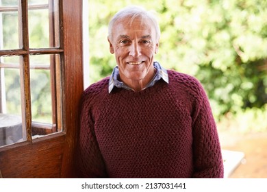 Invite an old man inside. Portrait of a happy senior man leaning against the doorway to his home. - Powered by Shutterstock